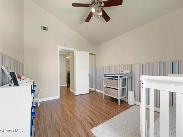 a view of a livingroom with wooden furniture and staircase