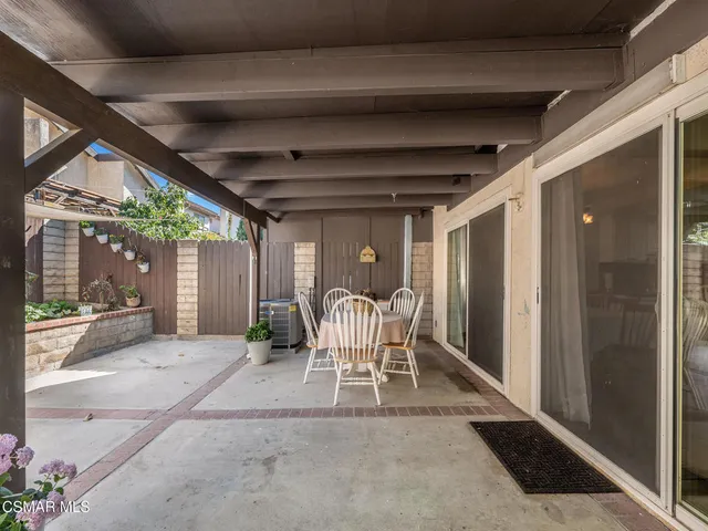 a view of a patio with table and chairs and potted plants