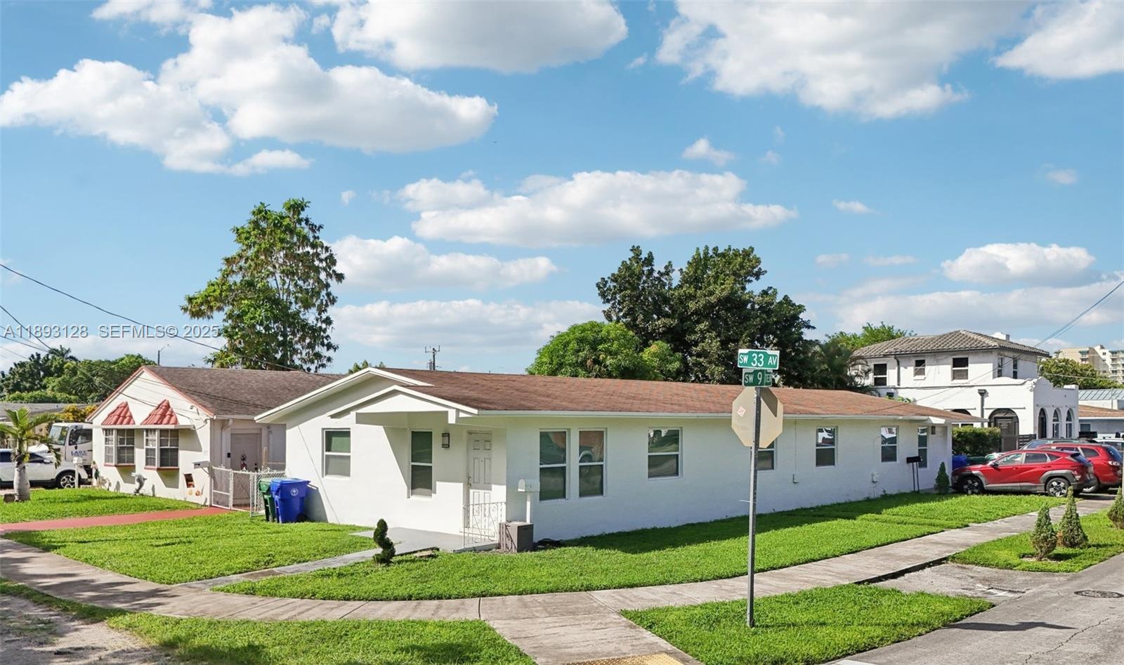 3300 Southwest 9th Terrace Miami, FL 33135 - Photo 1 of 25 a front view of a white house with a yard and potted plants