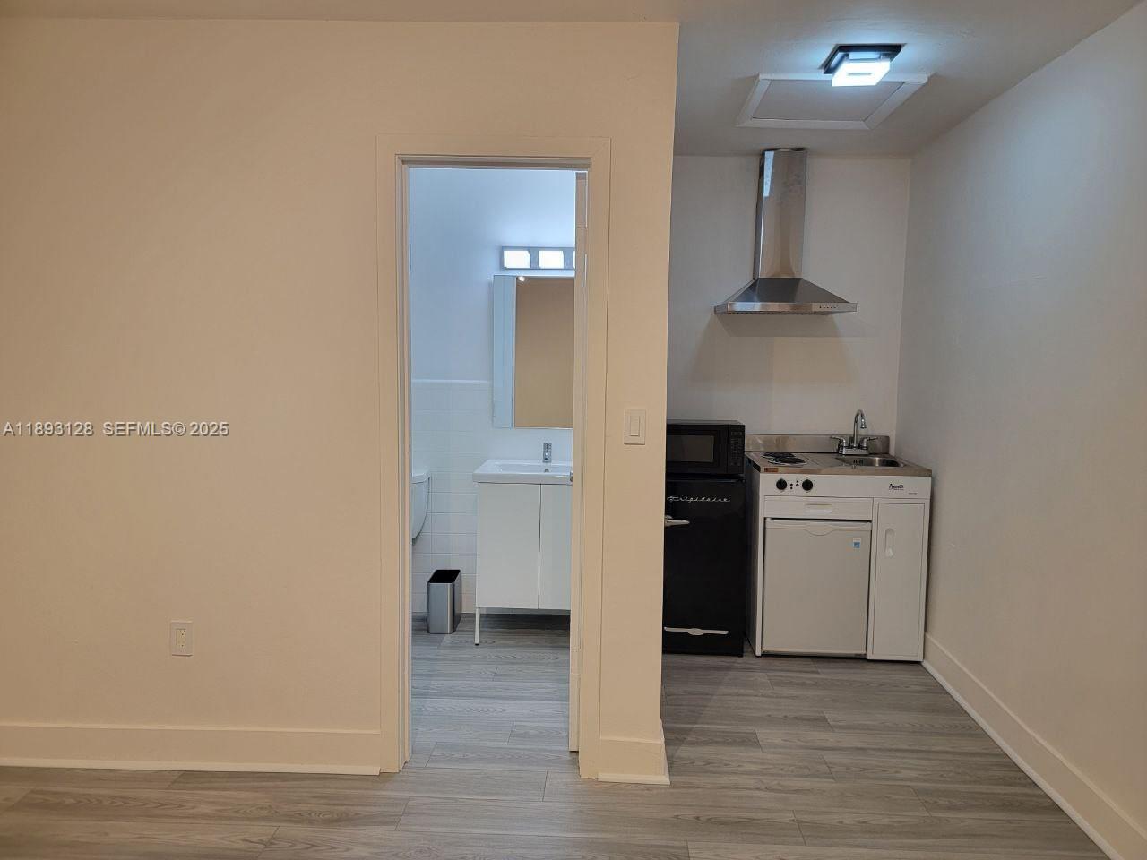 3300 Southwest 9th Terrace Miami, FL 33135 - Photo 11 of 25 a view of kitchen and sink with wooden floor