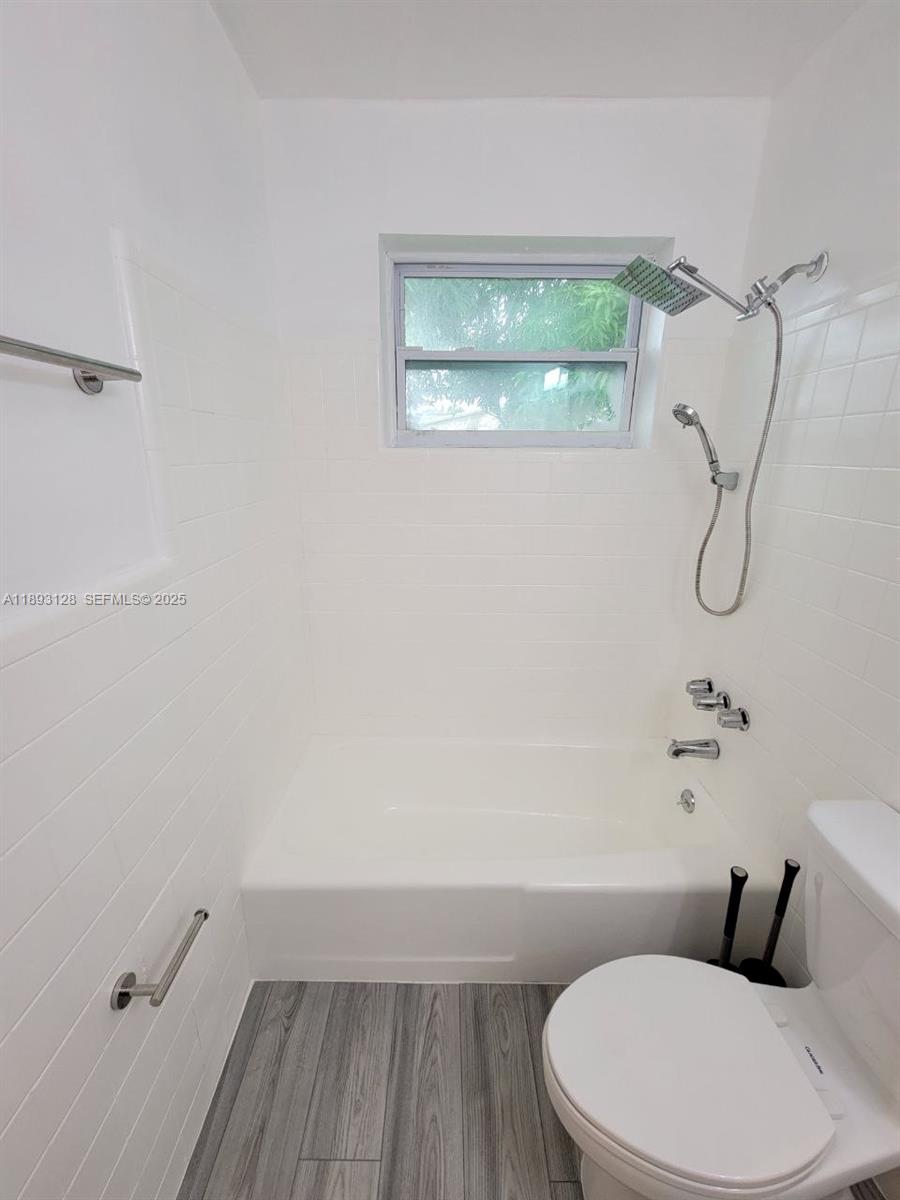 3300 Southwest 9th Terrace Miami, FL 33135 - Photo 12 of 25 a white toilet sitting next to a bathroom sink and a shower