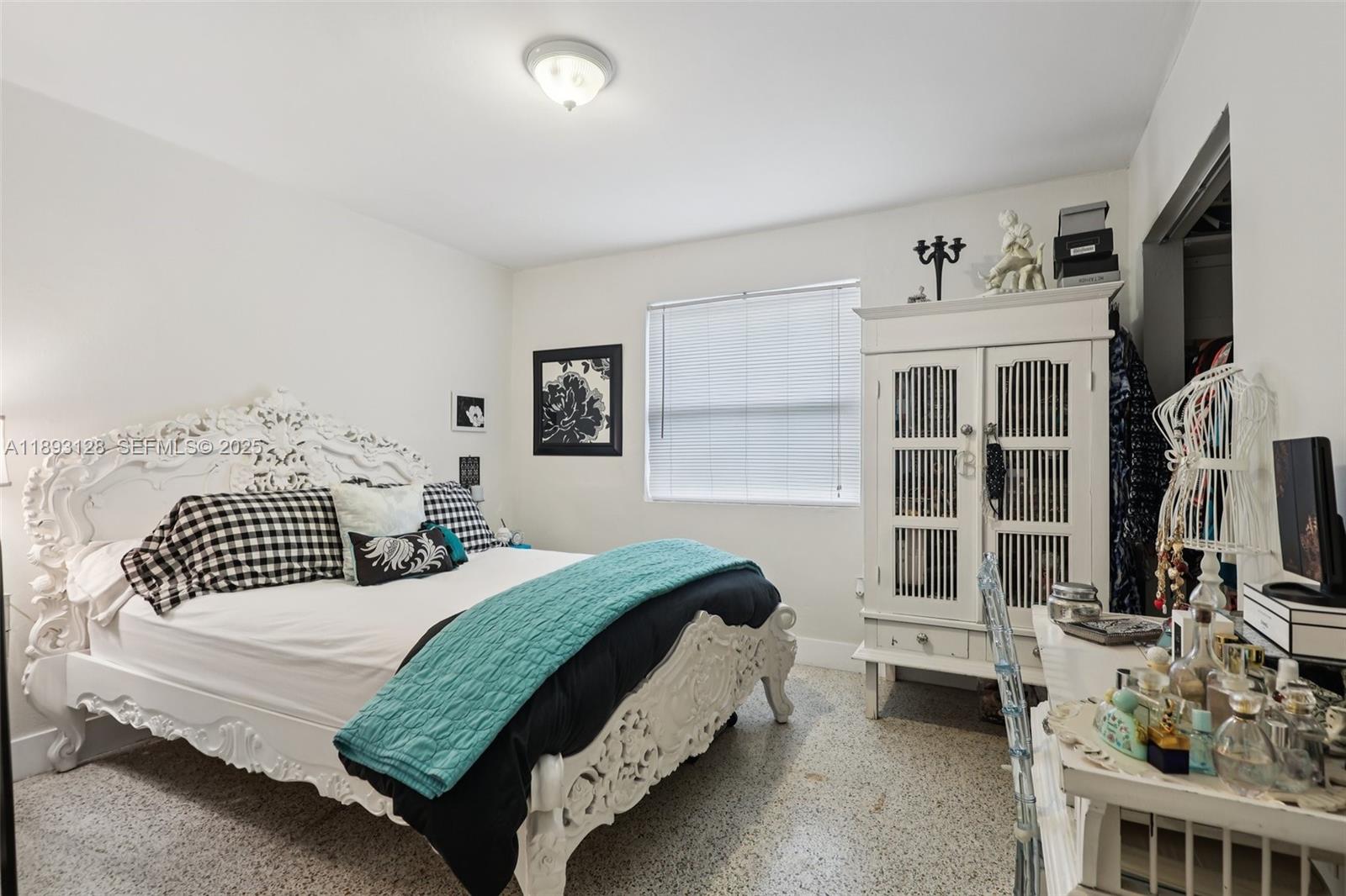 3300 Southwest 9th Terrace Miami, FL 33135 - Photo 19 of 25 a bedroom with a bed a flat screen tv and dresser