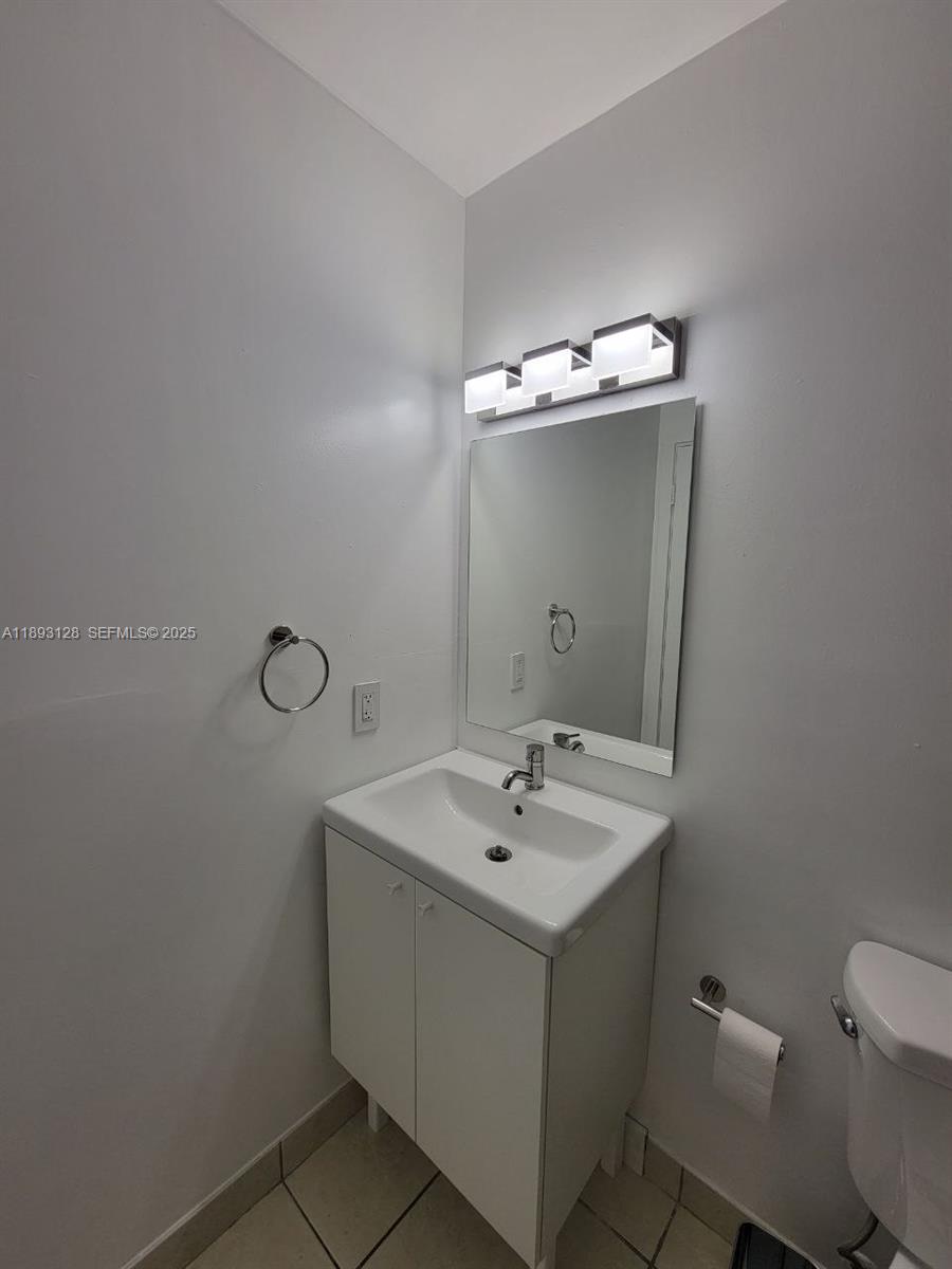 3300 Southwest 9th Terrace Miami, FL 33135 - Photo 21 of 25 a bathroom with a sink vanity and a toilet