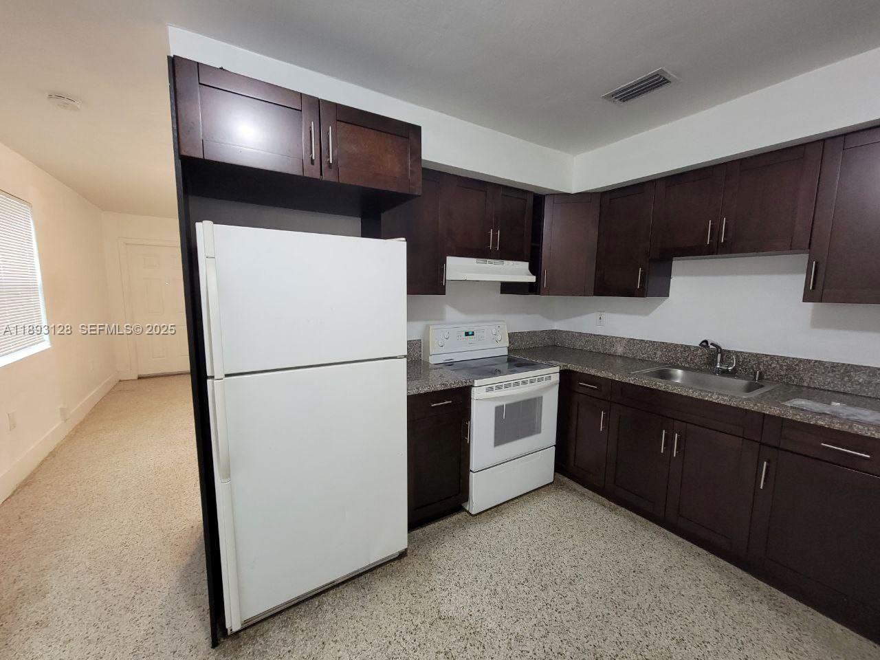 3300 Southwest 9th Terrace Miami, FL 33135 - Photo 22 of 25 a kitchen with a refrigerator sink and stove