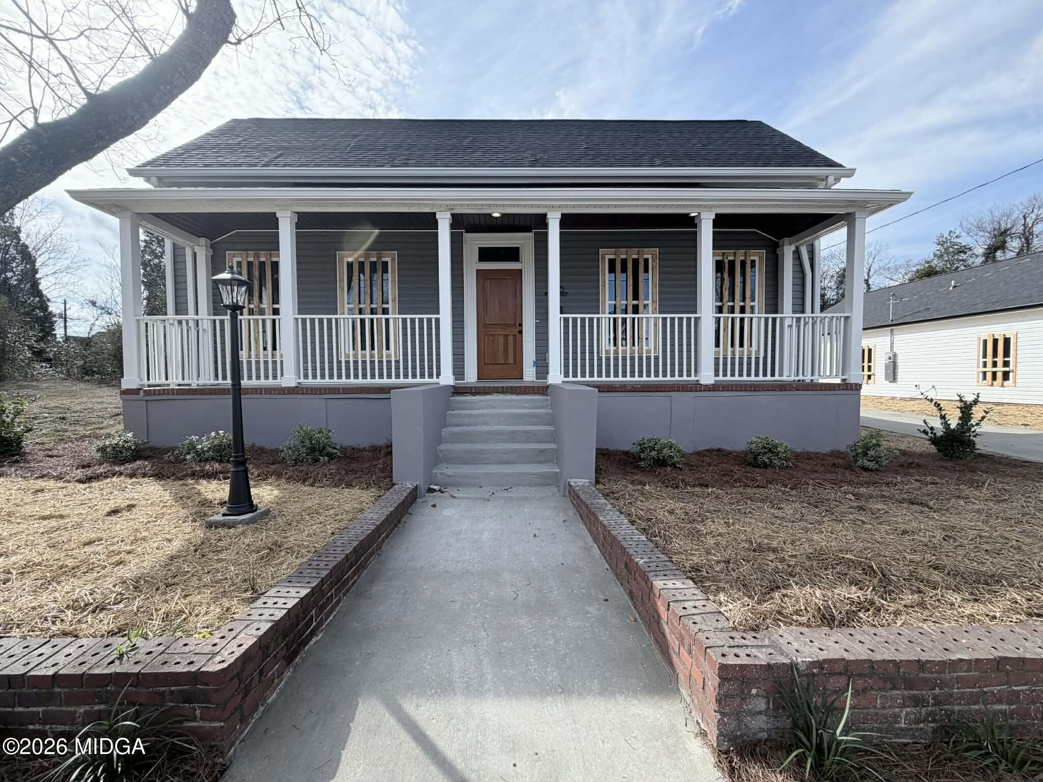 a front view of a house with trees