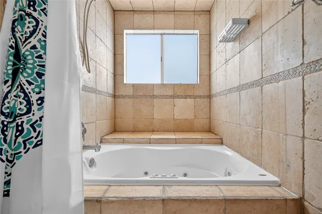 a bathroom with a bathtub and shower