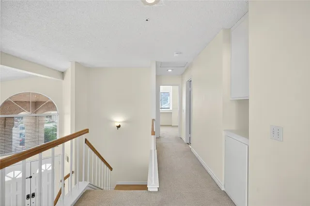 a view of a livingroom with wooden floor and stairs