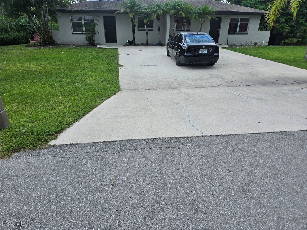 5487 Judith Road Bokeelia, FL 33922 - Photo 1 of 18 a car parked in front of a house
