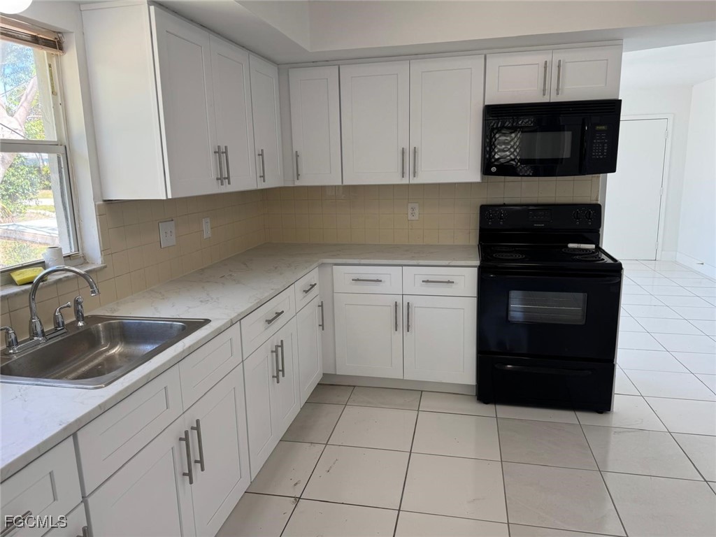 5487 Judith Road Bokeelia, FL 33922 - Photo 11 of 18 a kitchen with a sink and a stove