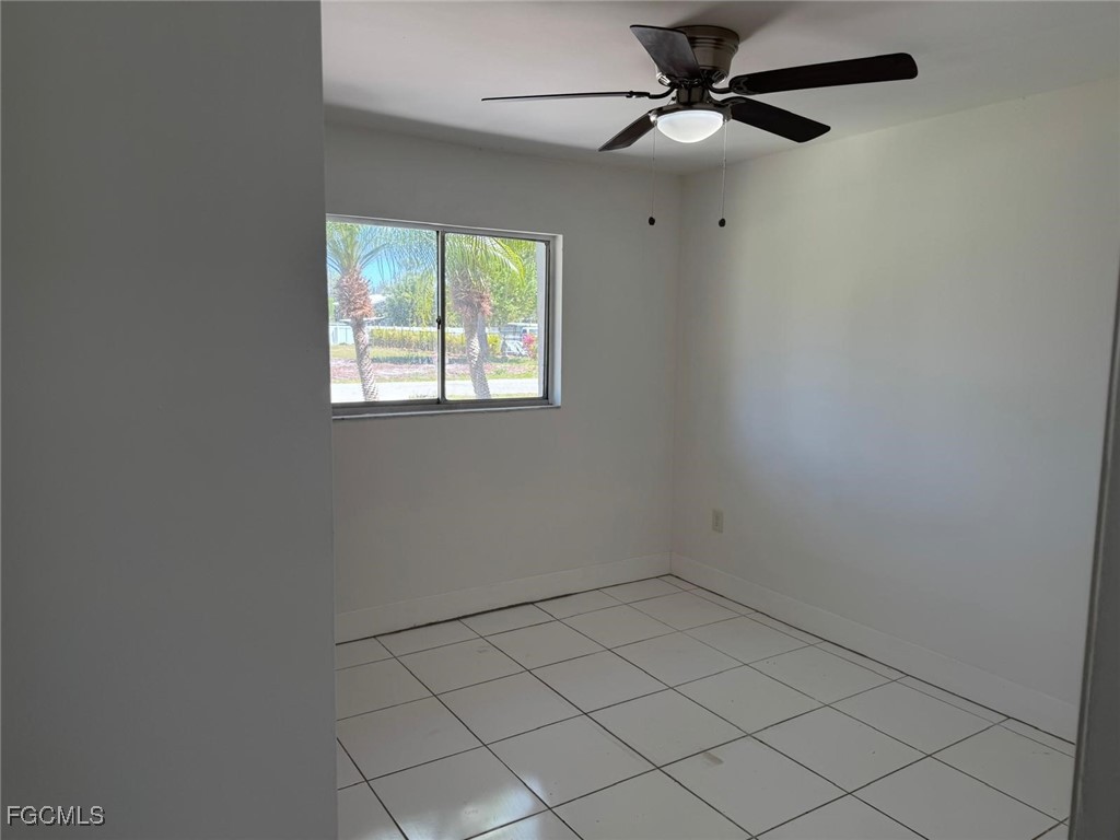 5487 Judith Road Bokeelia, FL 33922 - Photo 14 of 18 an empty room with a window and a fan