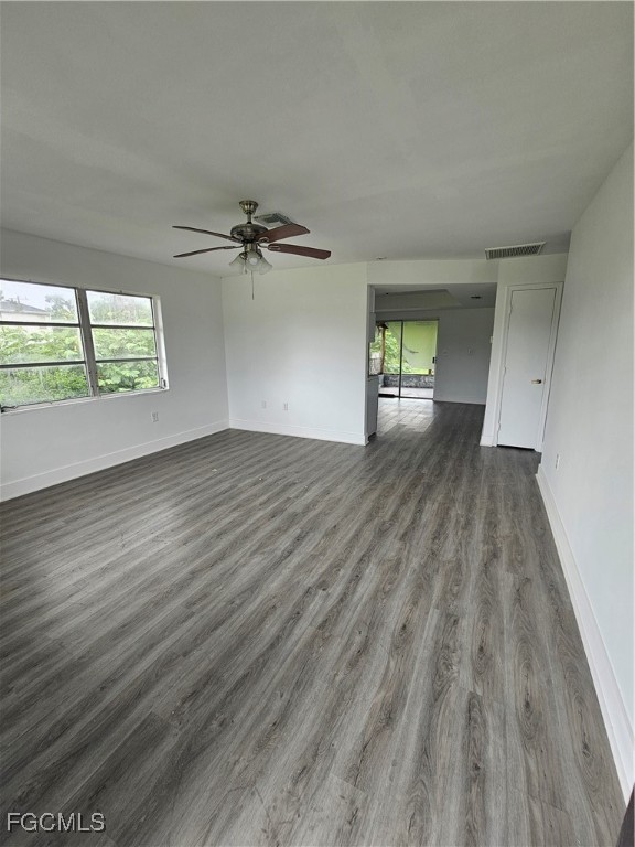 5487 Judith Road Bokeelia, FL 33922 - Photo 3 of 18 wooden floor in an empty room with a window