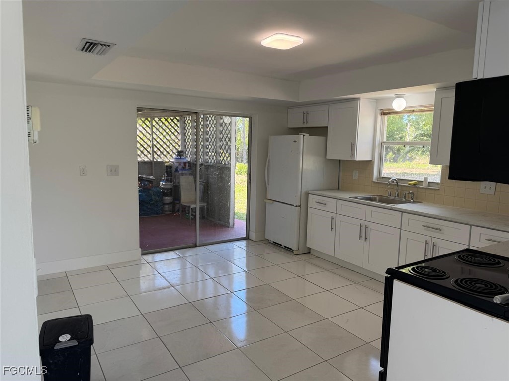 5487 Judith Road Bokeelia, FL 33922 - Photo 10 of 18 a kitchen with a sink a stove and refrigerator