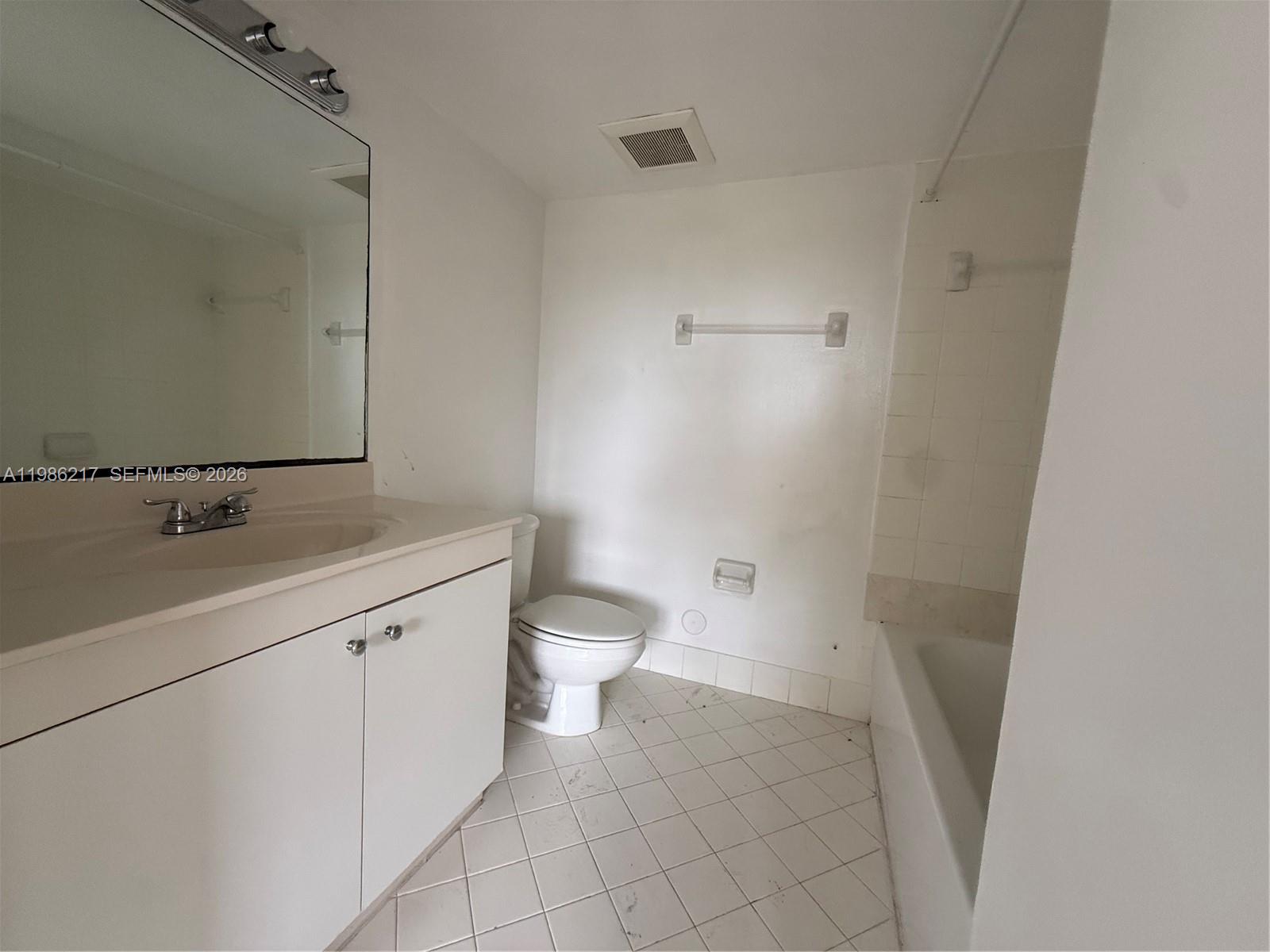 940 Northeast 33rd Terrace, Unit 101 Homestead, FL 33033 - Photo 12 of 20 a bathroom with a sink and a toilet