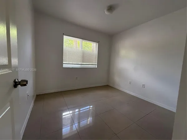 a view of an empty room with a window
