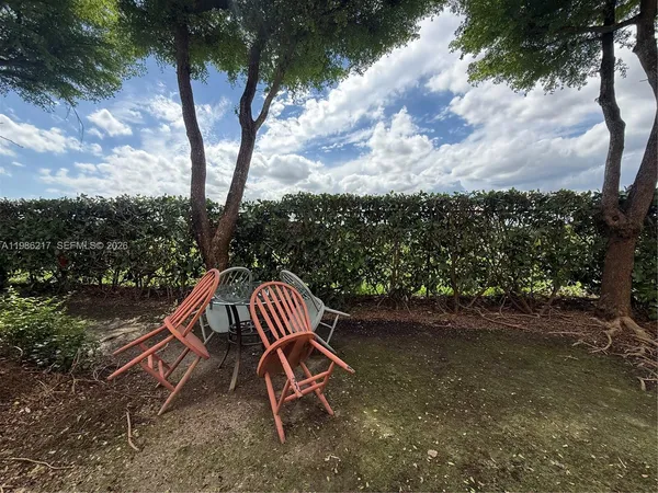a view of a wooden deck with a bench and wooden fence
