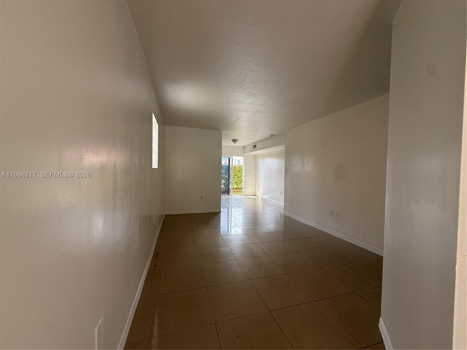 940 Northeast 33rd Terrace, Unit 101 Homestead, FL 33033 - Photo 5 of 20 a view of a hallway with wooden floor