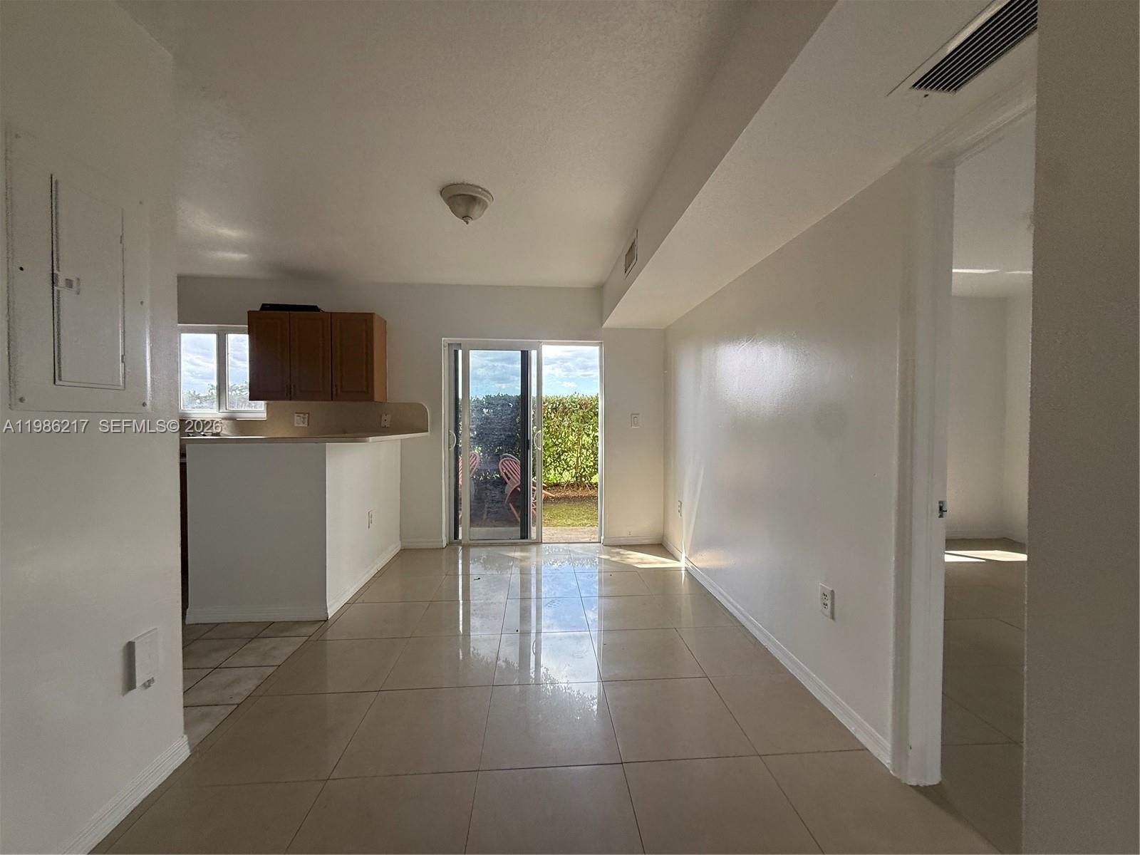 940 Northeast 33rd Terrace, Unit 101 Homestead, FL 33033 - Photo 6 of 20 a view of a kitchen with a sink and a microwave