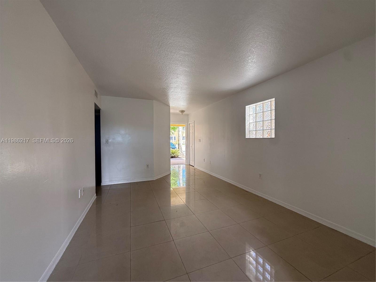 940 Northeast 33rd Terrace, Unit 101 Homestead, FL 33033 - Photo 10 of 20 an empty room with windows