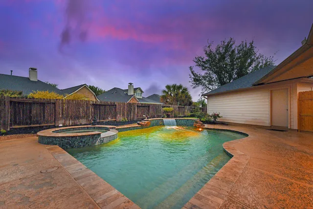 a view of a house with swimming pool and sitting area