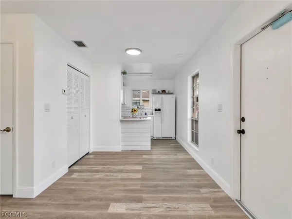 a view of a kitchen with wooden floor
