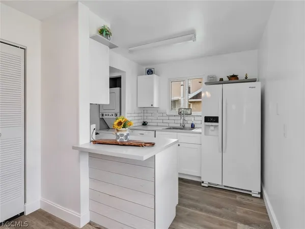 a kitchen with refrigerator and cabinets