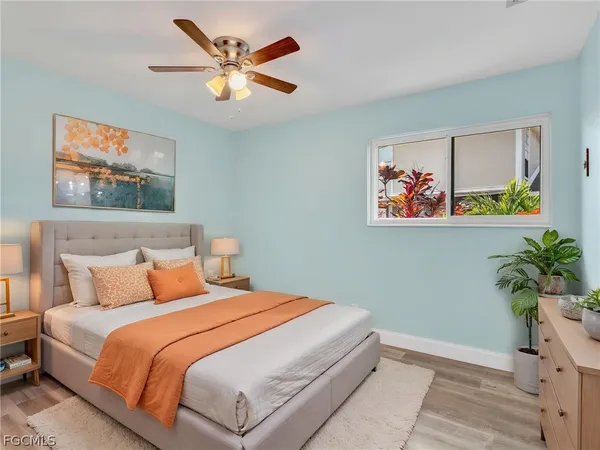 a bedroom with bed and wall painting