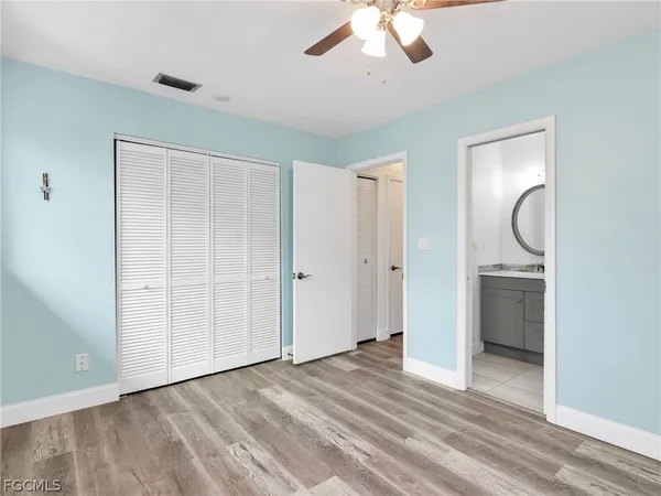 an empty room with a bathroom and a mirror