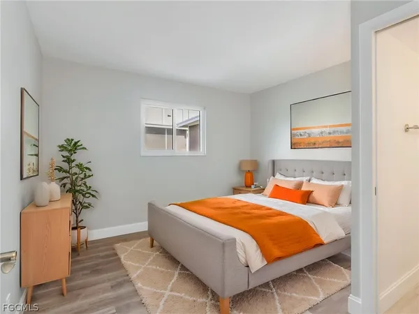 a bedroom with a bed and a potted plant