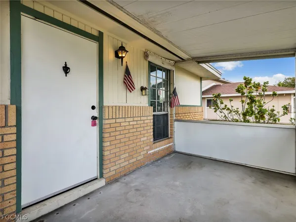 a view of a porch with wooden floor and fence