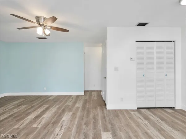 a view of an empty room with wooden floor