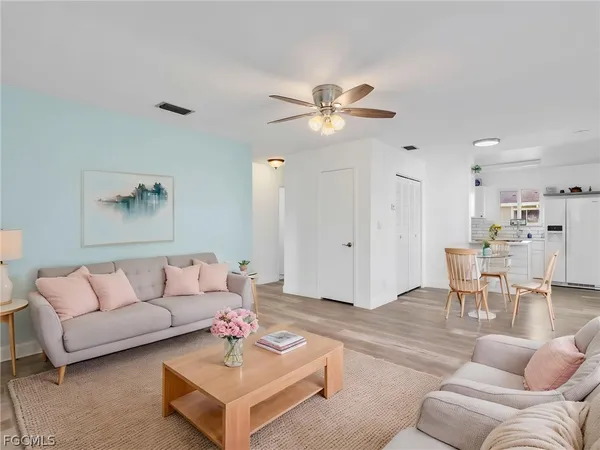 a living room with furniture and kitchen view