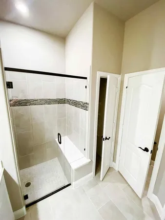 a bathroom with a shower and a mirror
