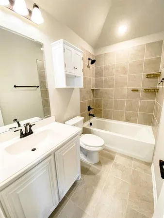 a bathroom with a sink a toilet and bathtub