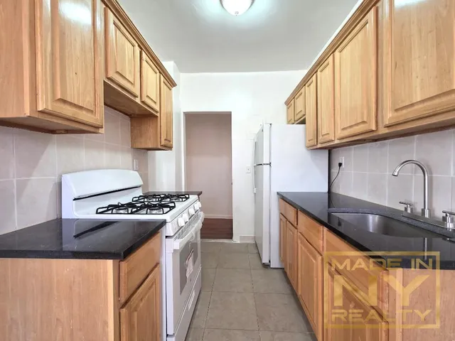 a kitchen with stainless steel appliances granite countertop a stove and a sink