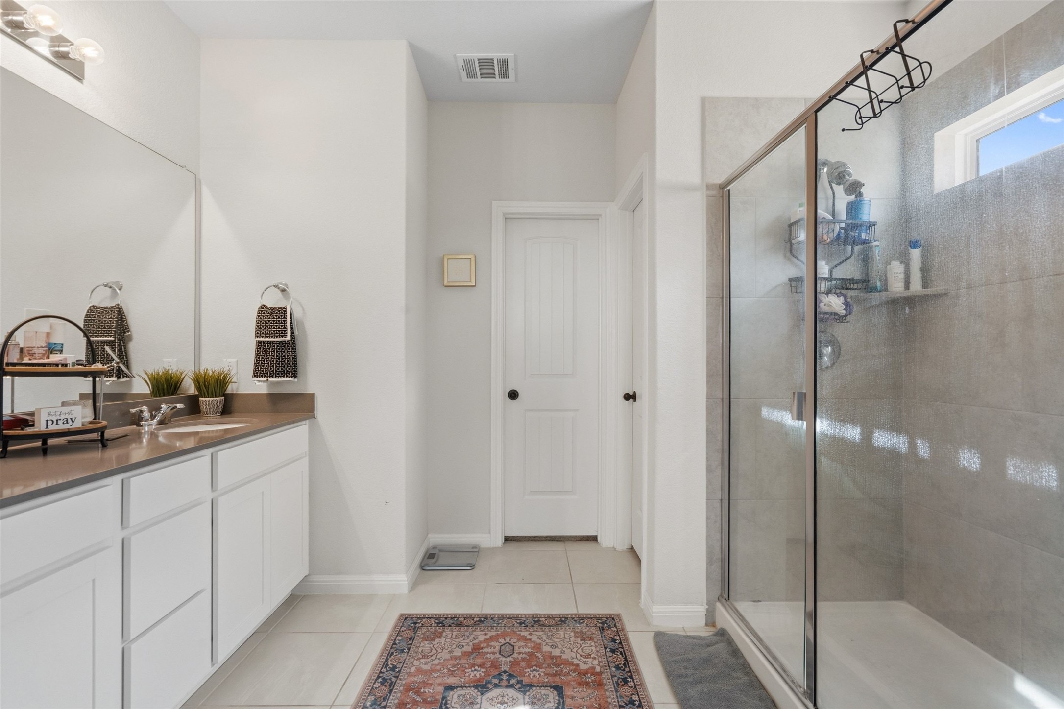 100 Panico Road Hutto, TX 78634 - Photo 22 of 28 Tiled flooring and a spacious walk-in shower elevate daily routines in this well-appointed bathroom.