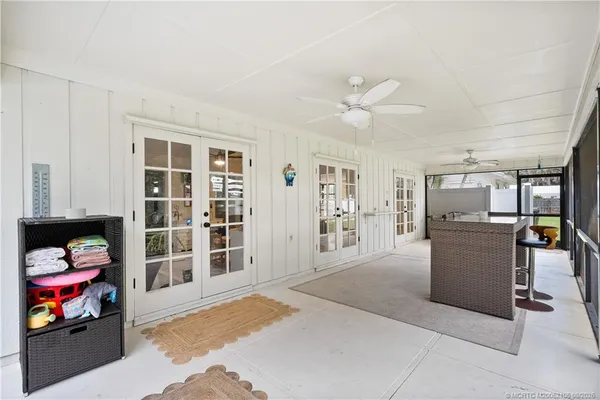 a view of a porch with furniture and a yard