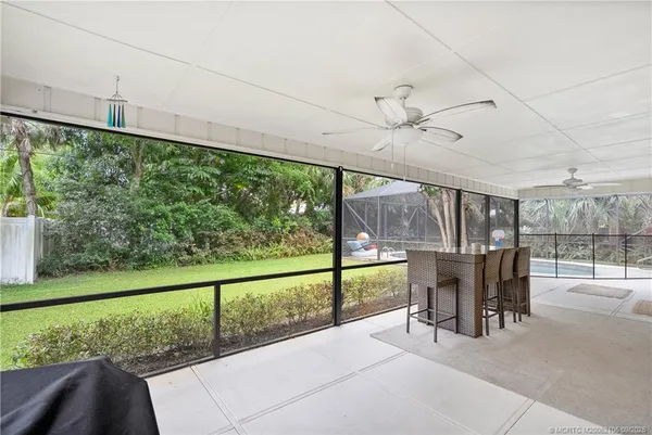 a view of a hallway with wooden floor and entryway