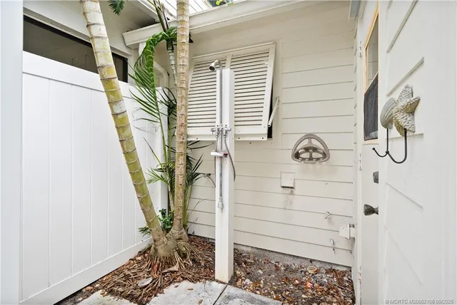 a bedroom with a bed and a mirror on the dresser