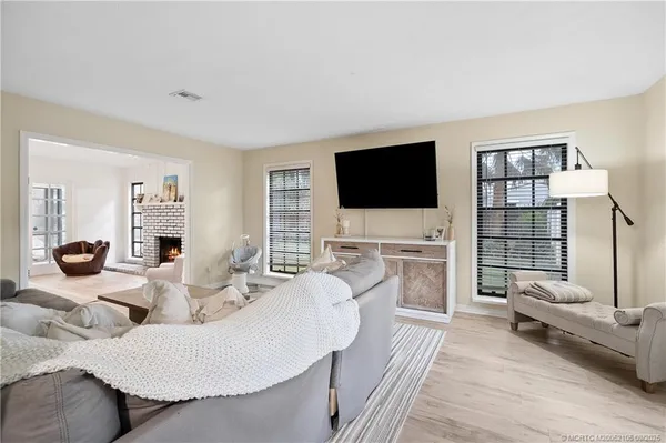 a living room with furniture window and flat screen tv