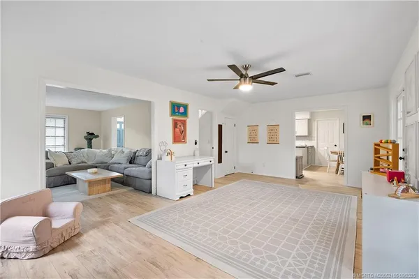 a living room with a fireplace and a four windows