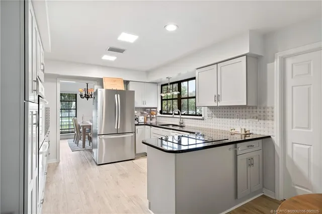 a kitchen with lots of counter top space and wooden floor
