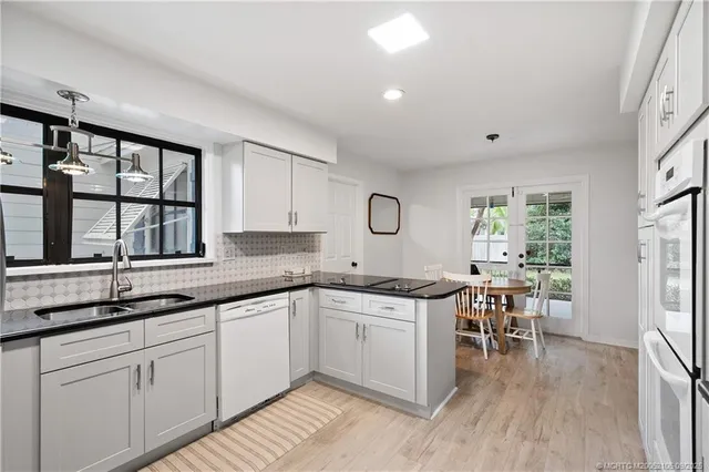 a kitchen with cabinets stainless steel appliances and counter space