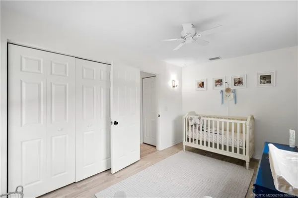 a bedroom with a bed flat screen tv and a window