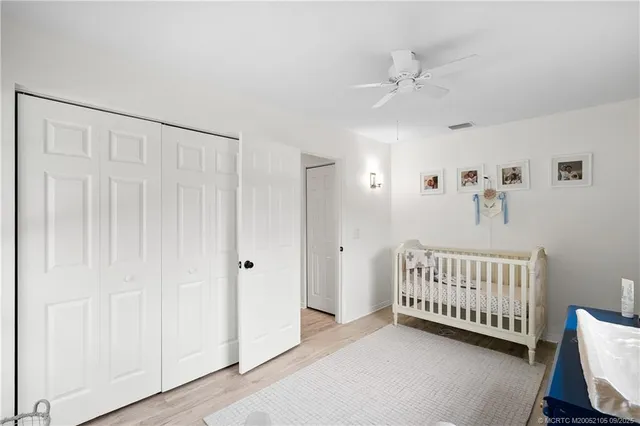 a bedroom with a bed flat screen tv and a window