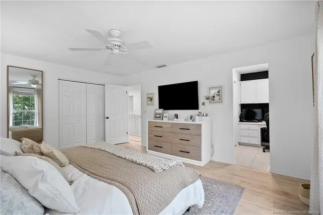 a bathroom with a toilet sink a mirror and vanity