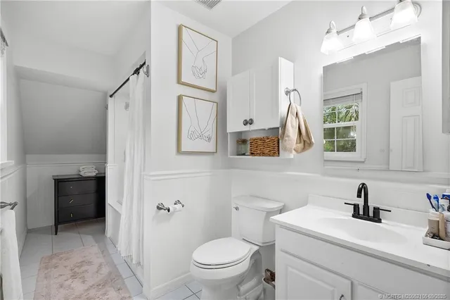 a bathroom with a shower a toilet and a sink