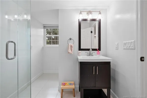 a view of a hallway with wooden floor and closet area