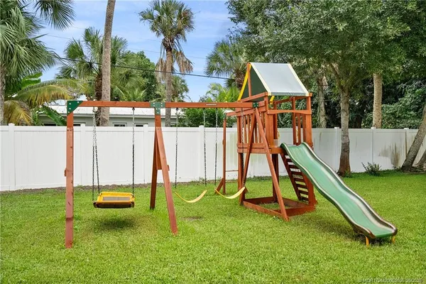 a view of playground with a slide and swing