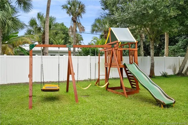 a view of playground with a slide and swing