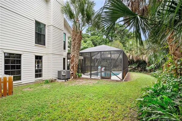 a view of a chair and table in backyard of the house